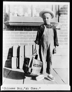 Chinese boy holding a round basket, Los Angeles, Chinatown