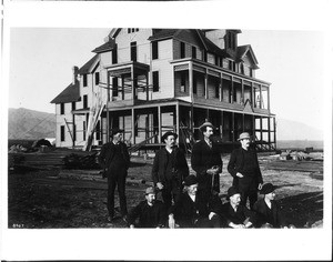 Group of men in front of the unfinished First Hotel in Corona, ca.1888