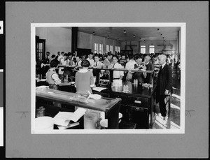 Interior view of a classroom in which students are working with vials of chemicals