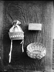 Three unidentified Indian baskets on display, ca.1900