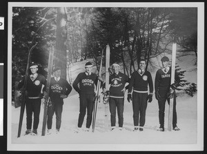 Six male skiers posing in a line, ca.1930