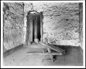 Interior view of Mission San Jose, showing a wooden field-plow, ca.1900