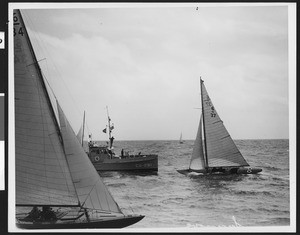 Unmanned sailboat being approached by a gunboat, ca.1940