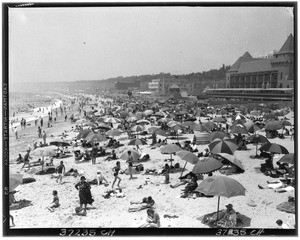 Crowded beach, showing people sunbathing