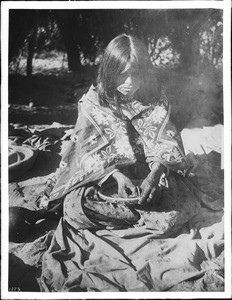 Havasupai Indian woman, Ta-vu-su-ja, making a "Kun" basket, ca.1900