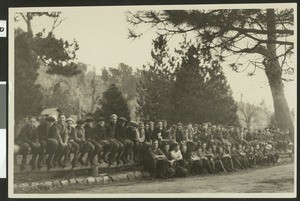 Group of boys seated on a fence, ca.1920