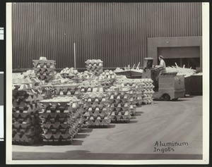 Aluminum ingots on a loading dock, ca.1930