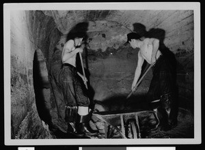 Department of Public Works employees cleaning debris from a storm drain from a flood on March 2, 1938