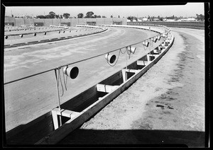 Rows of speakers in the parking lot of an empty drive-in movie theater