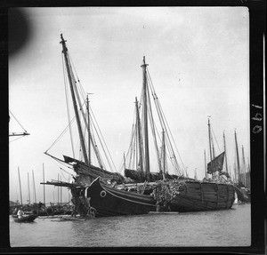 "Small" coastal junk loaded with timber at port in China, ca.1900