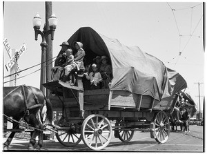 Large wooden stage coach or Conestoga wagon near a railroad crossing