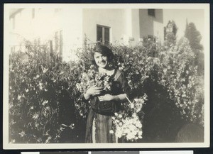 Portrait of a woman collecting bundles of flowers