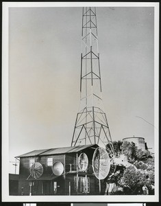 Two-story building with satellite dishes of various sizes, ca.1950