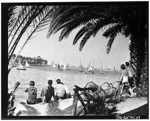 Bathers watching sailboats go by at Alamitos Bay in Long Beach