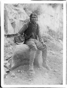 Havasupai Indian man, Waluthama, sitting on a rock, ca.1899