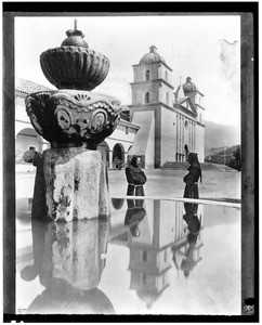 Fountain and monks outside of Mission Santa Barbara, ca.1901