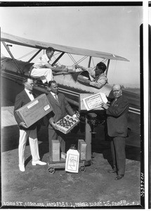 Inauguration of the Air Express Service, showing two pilots and three men in suits, August 31, 1927