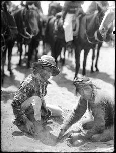 The two chiefs of the Navajos burying the rooster for the game of plucking the rooster, ca.1900