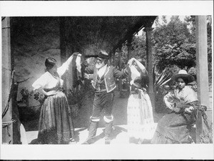 Portrait of Don Coronel dancing with two women at the old home, Los Angeles