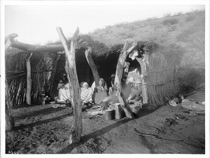 A family of escaped Yaqui Indians under a shelter in Arizona, ca.1910