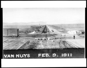 View of construction on Van Nuys Boulevard in Van Nuys, showing train tracks and Virginia Street, February 1911