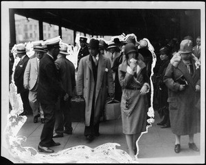 Passengers arriving at train station wearing winter clothing, December, 1927