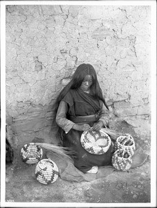 Hopi basket weaver, Koch-ye-amp-se, at Mishongnovi, Arizona, ca.1897