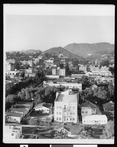 Panorama of Hollywood, showing Hotel Wilcox (foreground), and Hollywoodland sign on the mountains in the distance, 1927