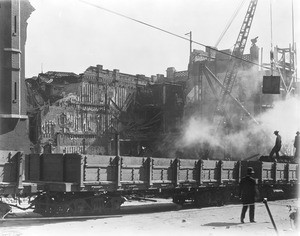 Cranes and workers on Broadway removing the rubble of the old Los Angeles Times Building the day after its bombing, October 1, 1910