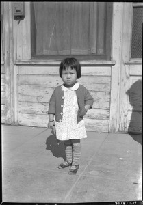 Portrait of a young Chinese girl on the sidewalk in Los Angeles's old Chinatown, November 1933