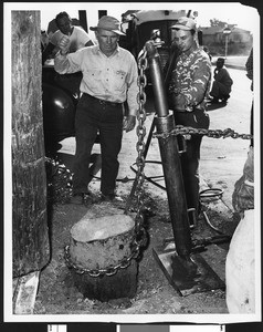 General Telephone Company remove the stump of a pole, ca.1940