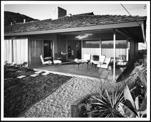 Furniture set on the patio of an unidentified 1950's-style home