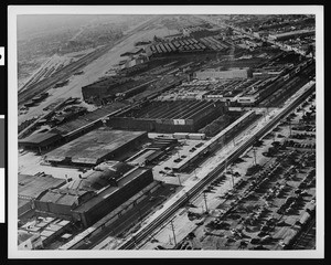 Aerial view of warehouse buildings next to a parking lot, Los Angeles