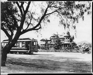 E.C. Hurd residence with a streetcar in the foreground on Hollywood Boulevard and Wilcox Avenue, California, 1900