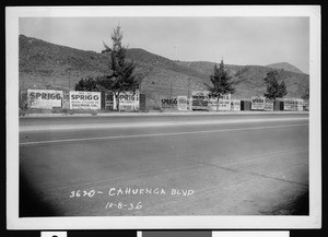 Large boxes on the side of Cahuenga Boulevard which advertise Sprigg Moving and Storage Company, 1936