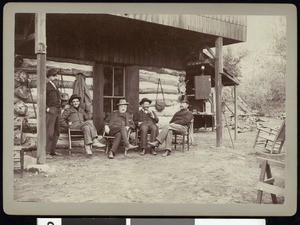 A group of fishing club members outside a mountain residence, ca.1910-1920