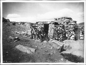 Peshliki, a Navajo Indian silversmith, and a friend outside his shop (and hogan) on the Tohatchi Indian Reservation near Gallup, New Mexico, ca.1901