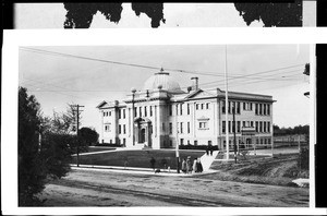 Exterior view of the Union High School in Whittier, showing pedestrians grouped at the sidewalk, ca.1910