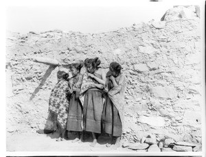 Four young Hopi Indian girls standing in a row in the village of Oraibi, ca.1900-1901