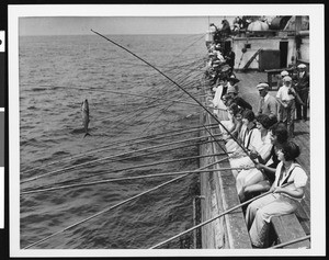 Men and women on a fishing barge, ca.1920