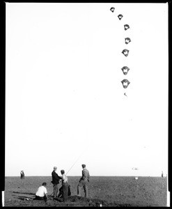 Group of men flying a kite at Dominguez Field, ca.1910