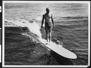Lone surfer riding the waves, ca.1950