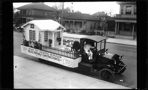 Pacific Portable Construction Company float advertising a Ready-Cut Colonial Bungalow, 1420 South Hill Street