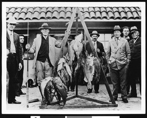 Men posing with their catch, ca.1930