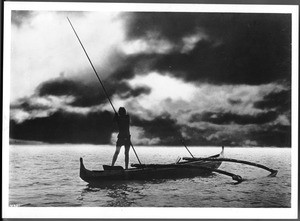 Hawaiian fisherman spearing fish from a boat