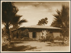 Exterior view of a one-story adobe with barrel tile roof