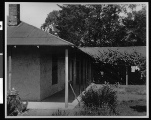 Exterior view of Canet Adobe, showing veranda of patio on north side of main building, Morro Bay, ca.1900