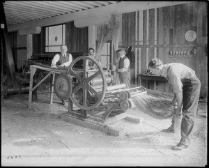 Four men demonstrating a ramie machine for making fiber, ca.1925