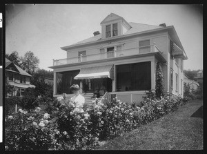 Group of women and roses in front of a residence in Roseburg, Oregon