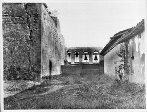 Bell tower and first church at Mission San Juan Capistrano, shown from the rear, ca.1899